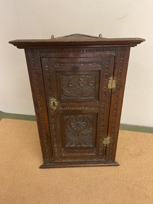 Lot 775 - A small carved oak corner cabinet, made with...