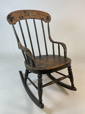 Lot 777 - A child's ebonised wood rocking chair with...