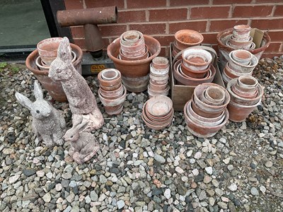 Lot 690 - A quantity of vintage terracotta flower pots,...