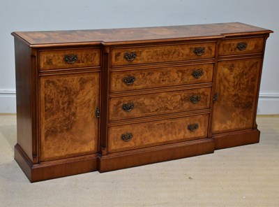 Lot 1047 - A reproduction walnut breakfront sideboard,...