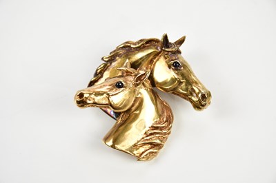 Lot 224 - A 9ct gold pendant modelled as two horse heads...