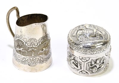 Lot 2489 - An Indian white metal cream jug decorated with...