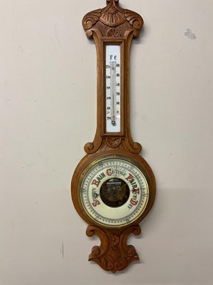 Lot 670 - A carved oak banjo dish dial barometer, with...