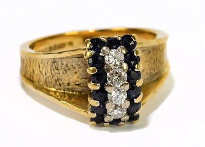 Lot 1042 - An 18ct yellow textured gold dress ring set...