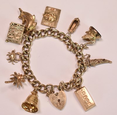 Lot 580 - A 9ct yellow gold charm bracelet set with...