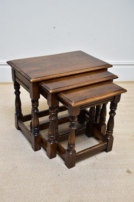 Lot 1117 - REPRODUX; a nest of three oak occasional tables.