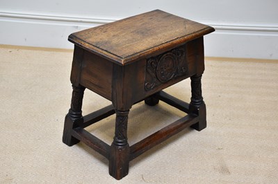 Lot 1221 - An 18th century oak stool with hinged seat and...