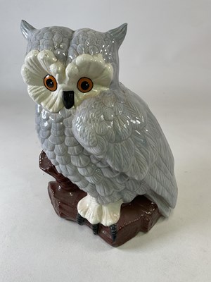 Lot 308 - A large ceramic eagle owl seated on a tree...