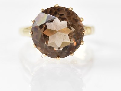 Lot 883 - A 9ct yellow gold ring set with a smoky quartz,...