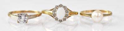 Lot 888 - A 9ct yellow gold ring set with an oval opal,...