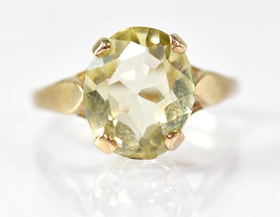 Lot 872 - A 9ct yellow gold ring set with a pale yellow...