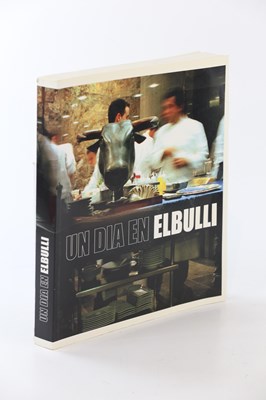 Lot 598 - UN DIA EN ELBULLI; paperback book containing...