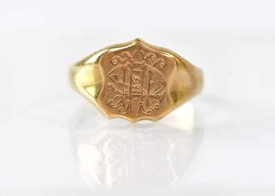 Lot 858 - A 9ct gold signet ring, the shield table with...