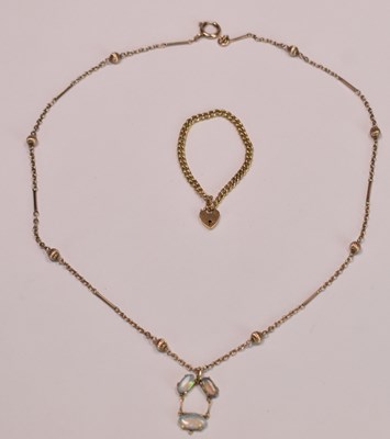 Lot 598 - A 9ct rose gold fancy link chain suspending a...