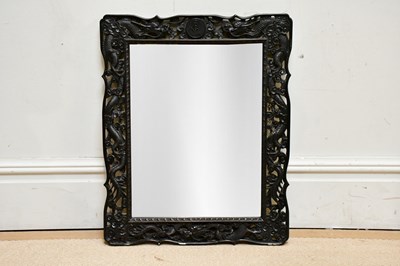 Lot 1112 - A Chinese ebonised carved wall mirror of...