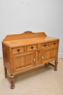 Lot 1208 - A light oak sideboard with raised arched back...