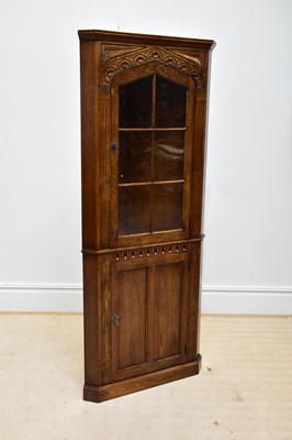 Lot 1071 - A reproduction carved oak freestanding corner...