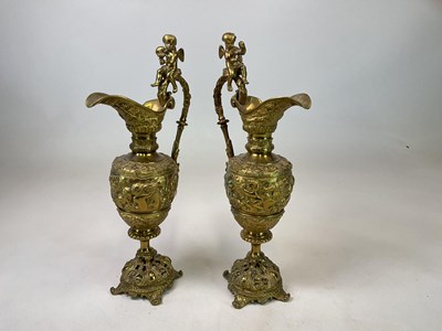 Lot 128 - A large and decorative pair of brass ewers,...