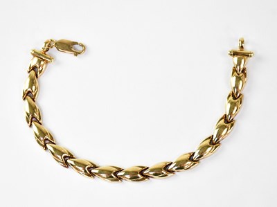 Lot 766 - A yellow metal hollow link bracelet, length...