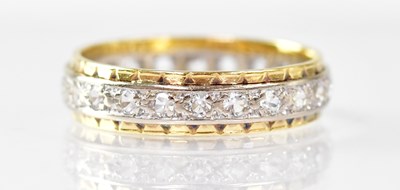 Lot 897 - An 18ct white and yellow gold eternity ring...