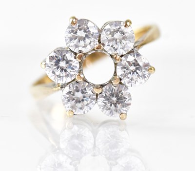 Lot 876 - A 9ct yellow gold floral ring set with six...