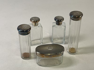 Lot 468 - A set of hallmarked silver topped toilet jars...