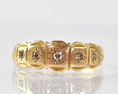 Lot 898 - An 18ct gold ring star set with five tiny...