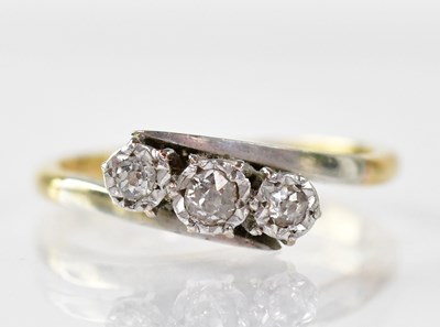 Lot 901 - An 18ct gold ring with three platinum set tiny...