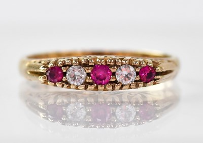 Lot 874 - A 9ct gold ring set with three rubies and two...