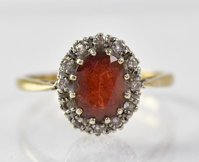 Lot 877 - A 9ct gold garnet and diamond ring, size T,...