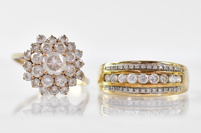 Lot 865 - Two 9ct gold dress rings, one set with three...