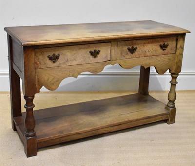 Lot 1069 - A reproduction oak dresser base with two...