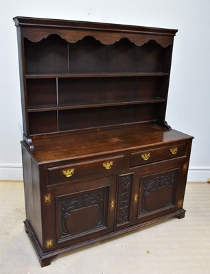 Lot 1252 - An early 20th century dark oak dresser, the...