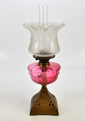 Lot 1543 - A modern oil lamp with cranberry glass...