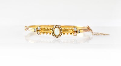 Lot 773 - A 9ct gold hinged bracelet decorated with...