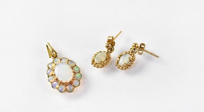 Lot 810 - An opal cluster pendant in a 9ct gold mount,...