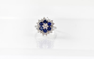 Lot 904 - An 18ct white gold floral cluster ring set...