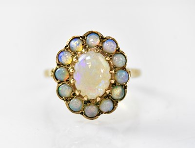 Lot 871 - A 9ct gold floral cluster ring, the central...