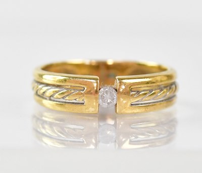 Lot 900 - An 18ct gold ring with small tension fit...