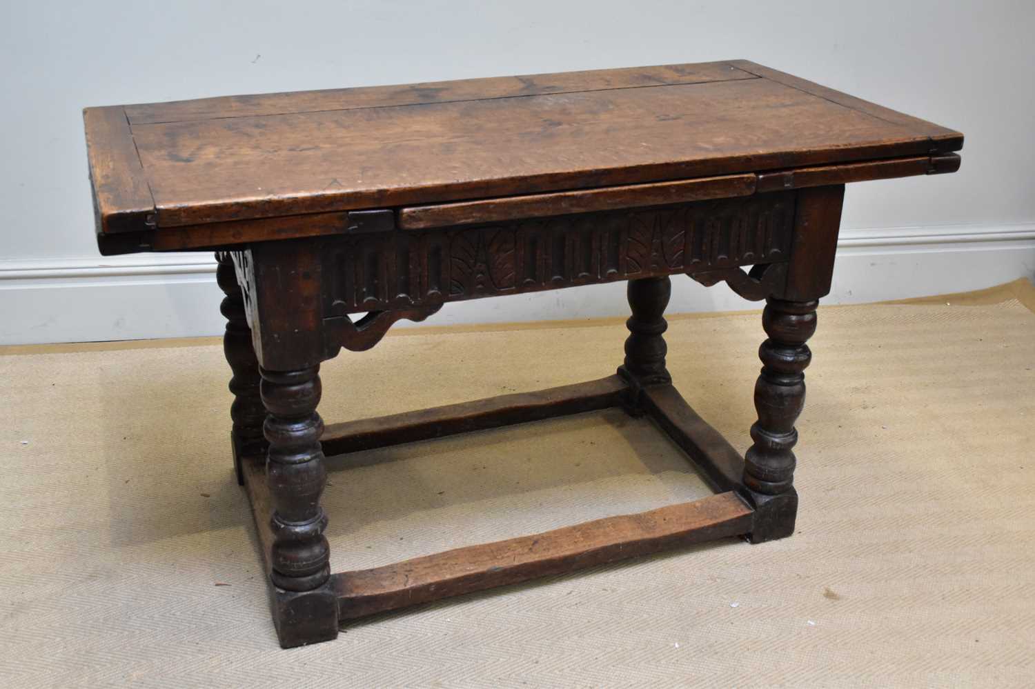 Lot 1372 - An oak draw-leaf refectory table with