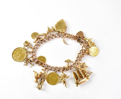 Lot 783 - A 9ct gold bracelet set with various charms to...