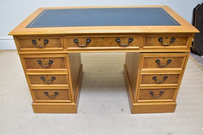 Lot 1120 - A reproduction kneehole desk with leather...