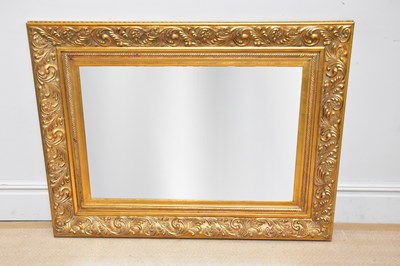 Lot 1099 - A modern gilt framed rectangular wall mirror,...