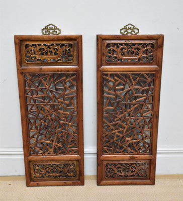 Lot 1100 - Two Chinese carved pine framed panels, 99 x 39cm.