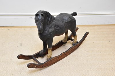 Lot 1137 - A painted papier-mâché rocking horse on...