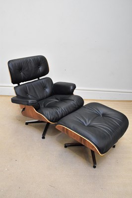 Lot 1053 - AFTER CHARLES & RAY EAMES; a black leather and...