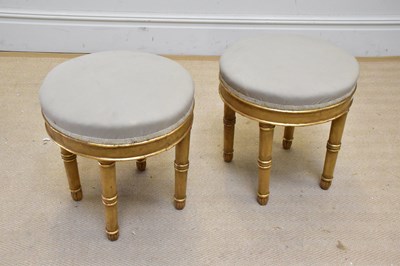 Lot 1098 - Two modern gilt stools on bamboo effect columns.