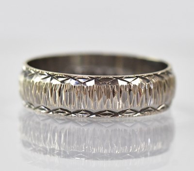 Lot 893 - An 18ct white gold band ring with textured...