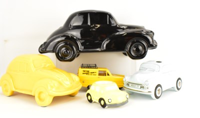 Lot 416 - Four ceramic and plastic ornamental cars,...