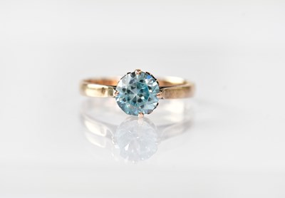 Lot 878 - A 9ct rose gold ring set with single pale blue...